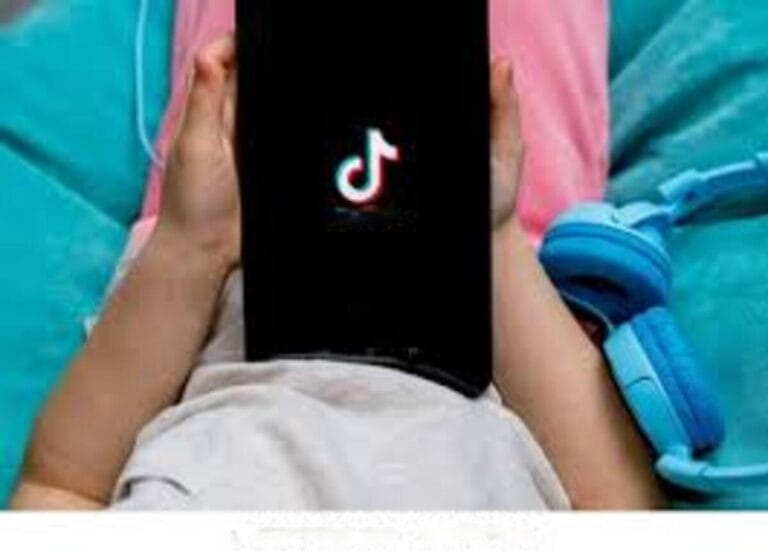 child holding phone with and displaying tiktok app